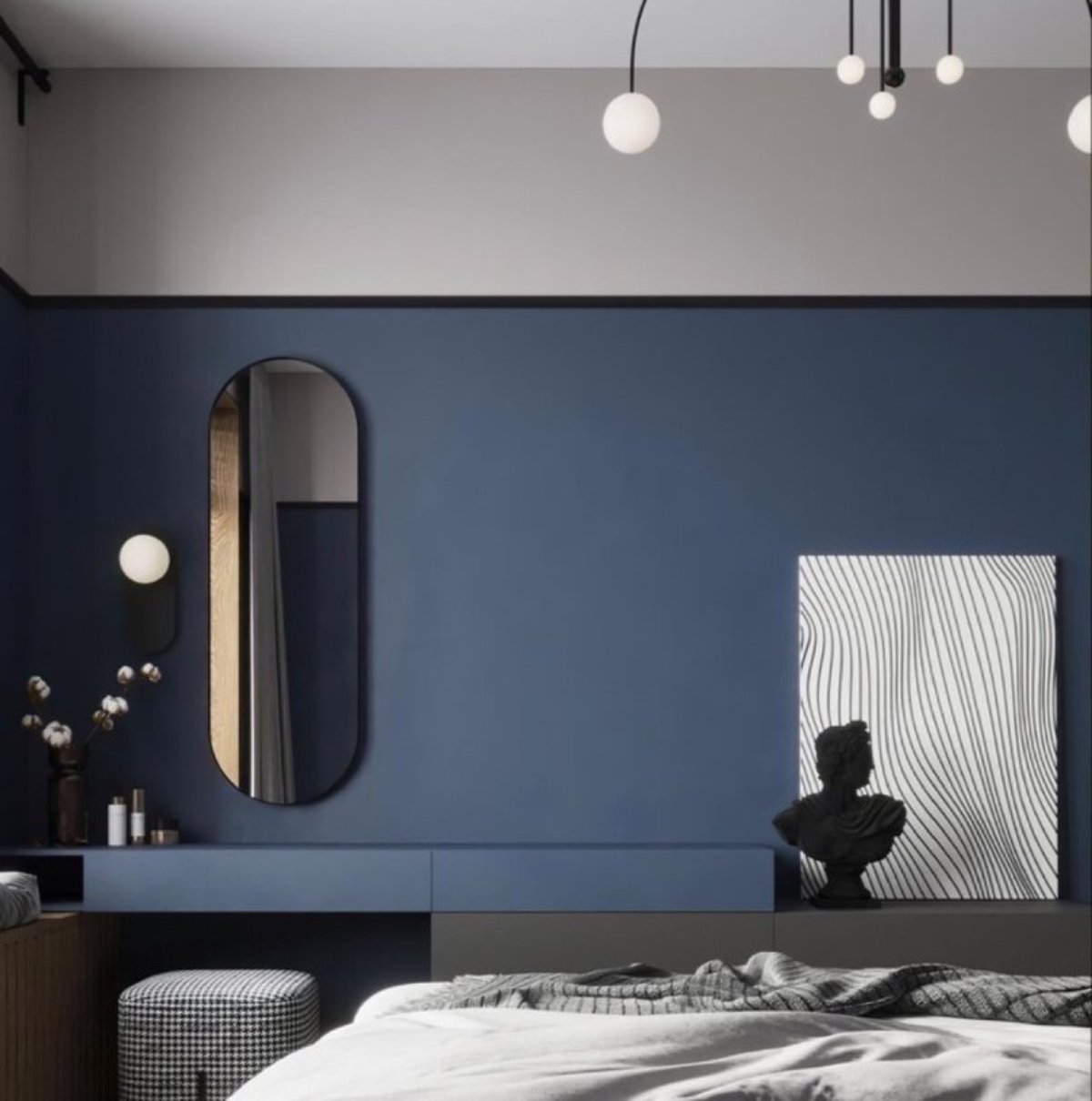 Modern bedroom featuring a navy blue wall, sleek furniture, a round mirror, minimalist decor, and stylish lighting fixtures.