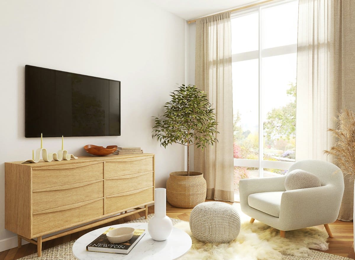 Cozy living room featuring an oak sideboard, a white plush armchair, a large window, potted plants, and soft textiles for a warm ambiance.
